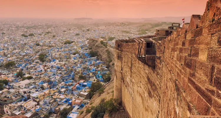 Rajasthan Tour, showcasing a panoramic view of Jodhpur's blue city from Mehrangarh Fort at sunset