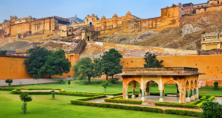 Amber Fort in Jaipur with lush gardens and historic pavilion, highlighting Amazing Rajasthan Tour.