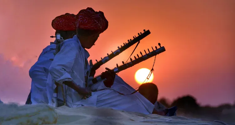 Rajasthani musicians playing traditional instruments at sunset on Classical Rajasthan tour.