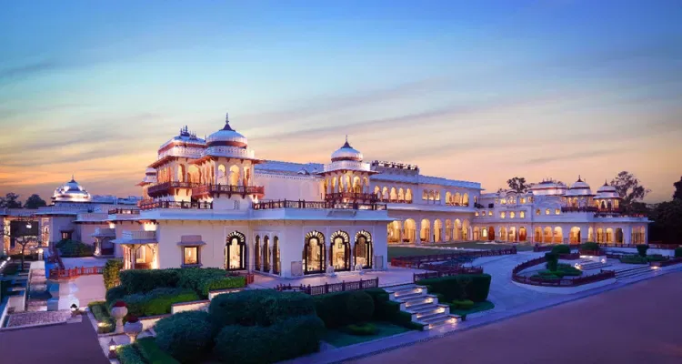 Rajasthan Forts, Palaces and Desert Tour, featuring a stunning Taj palace at dusk with ornate domes and arches