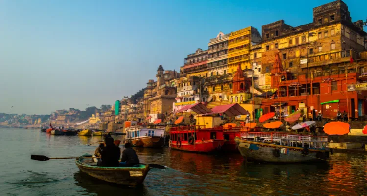 Golden Triangle with Varanasi Tour 7 Nights 8 Days, featuring a boat on the Ganges with colorful ghats