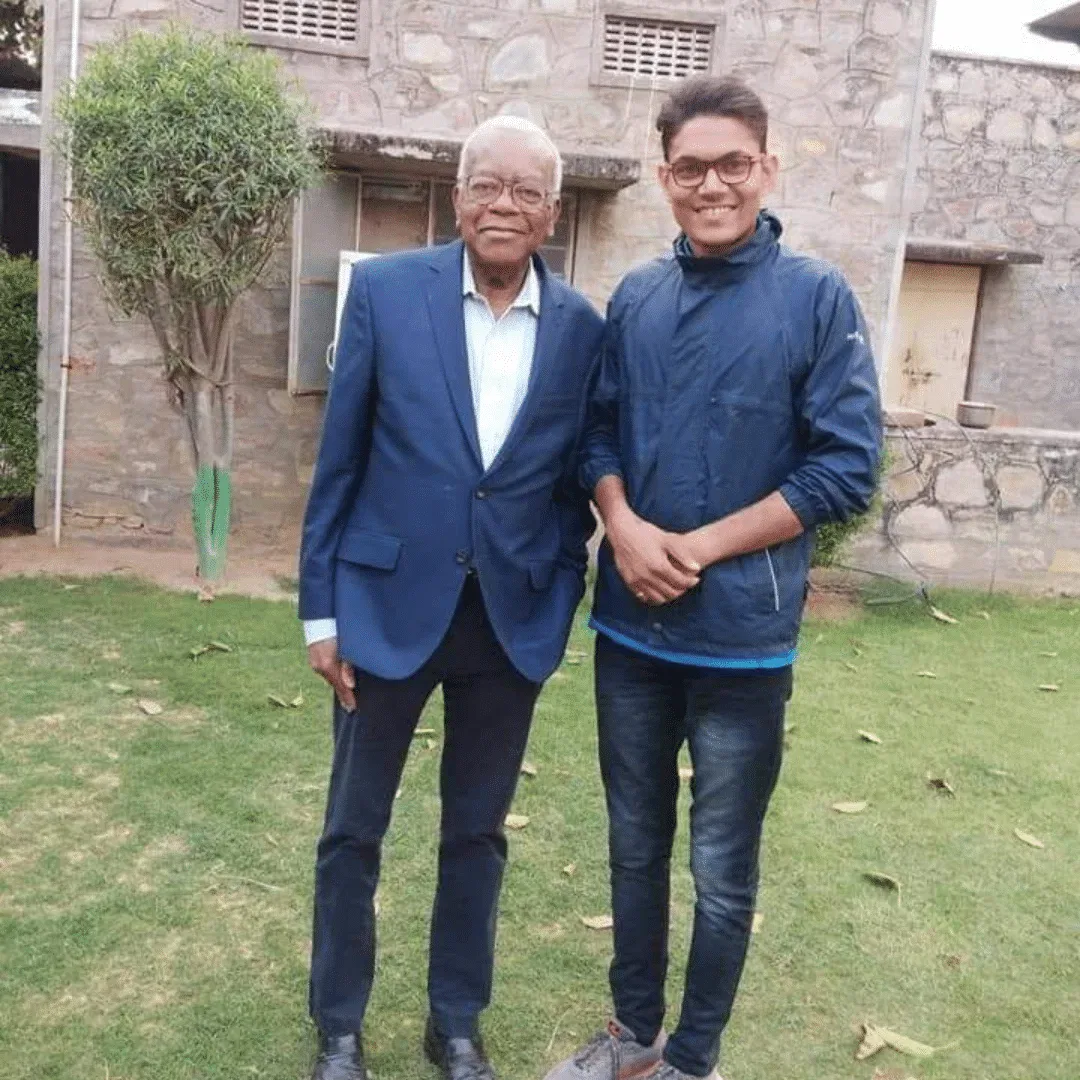 a old man and a boy are standing