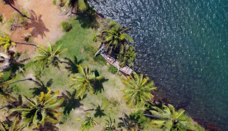a boat on the shore of a body of water