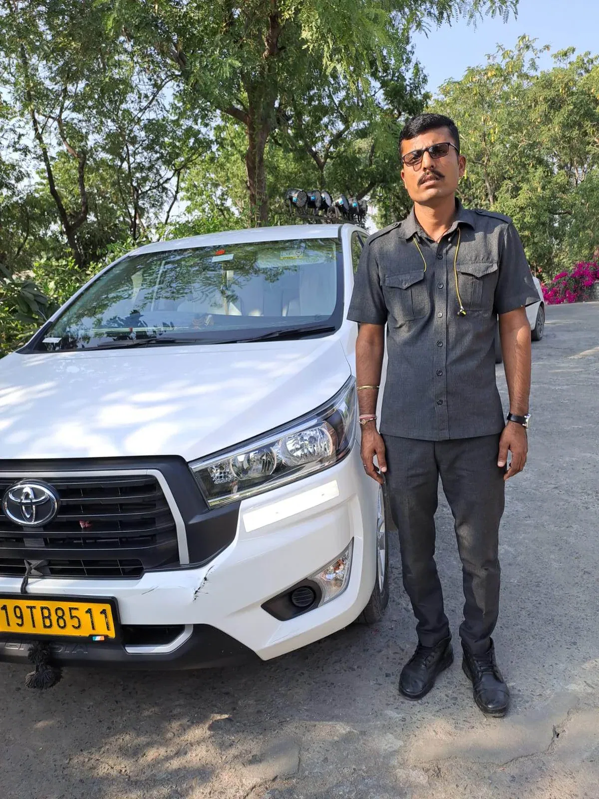 a man standing next to a parked car outdoors
