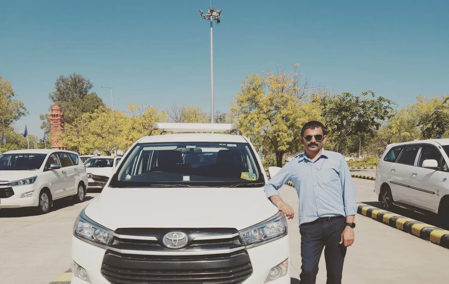 a man standing next to a white car