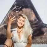 hippie girl with long blond hair in a dress on the roof.