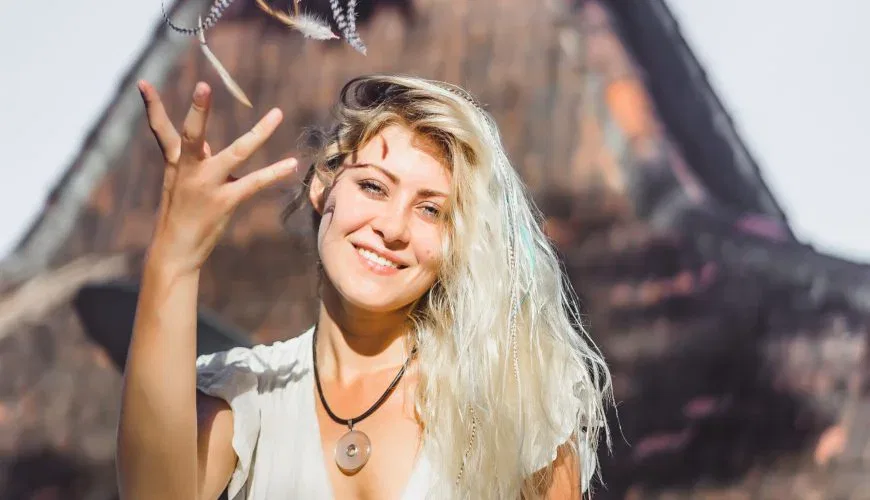 hippie girl with long blond hair in a dress on the roof.