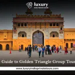 Tourists exploring historic fort gate in Jaipur during Golden Triangle tour in India